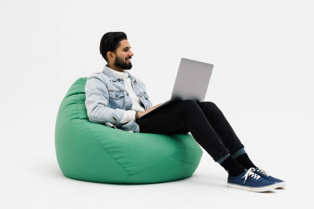 istock Handsome attractive man smiling beaming enjoying finishing his project isolated over grey color background 1368392786