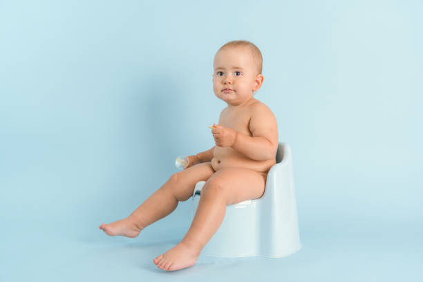 istock A one-year-old child is sitting on a plastic pot on a blue background. Potty training for newborns, copyspace 1368392925