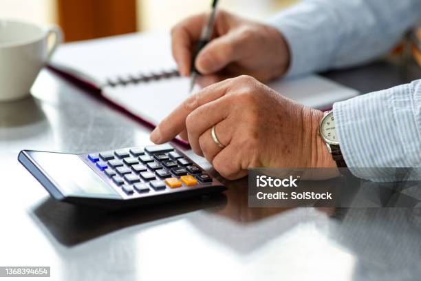 Calculating His Monthly Spend Stock Photo - Download Image Now - Home Finances, Budget, Savings