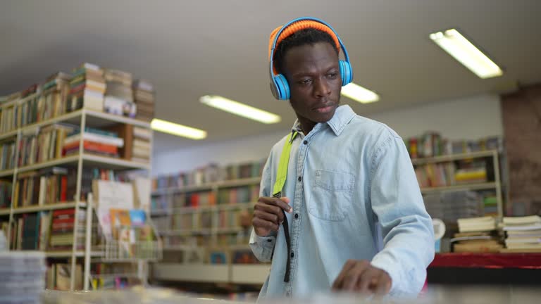 Man browsing compact disc in a music store