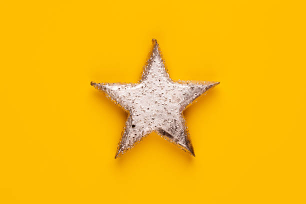 istock Christmas star decor on yellow colored background. 1368395847