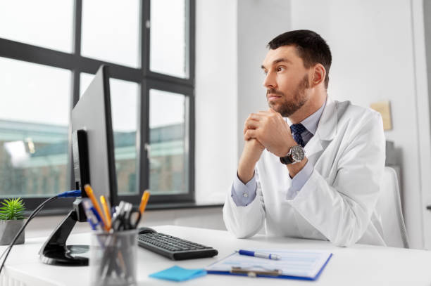 istock male doctor with computer working at hospital 1368396140