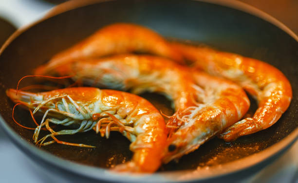 istock Cooking king prawns in a pan. 1368396417