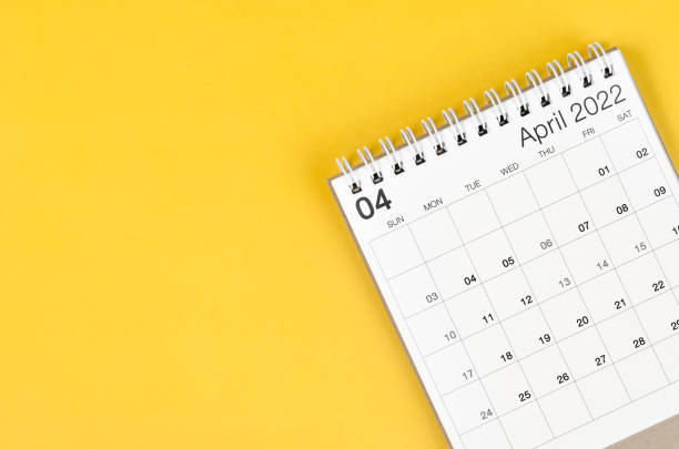 istock April 2022 desk calendar on yellow background with empty space. 1368397748