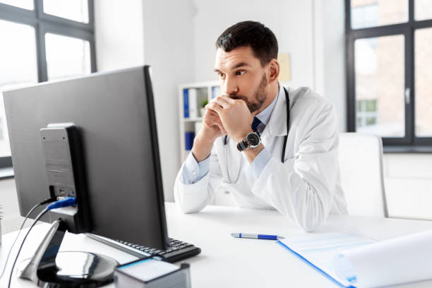 istock male doctor with computer working at hospital 1368398183