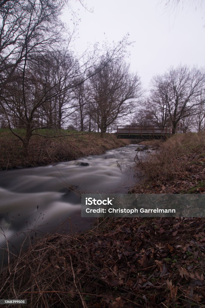 A flowing river Long Time exposure of a small river in Germany Bush Stock Photo