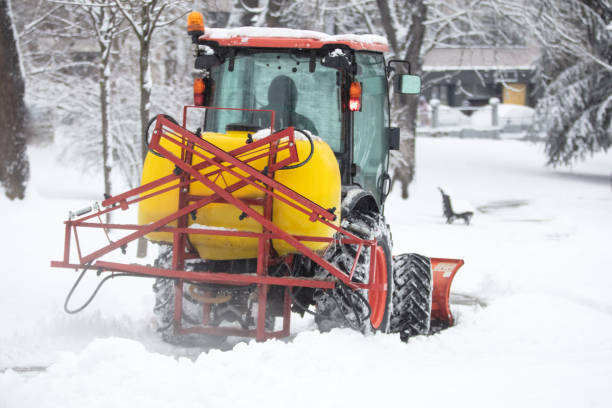 istock Tractor cleaning urban park paths on a cold snowy day. 1368399705