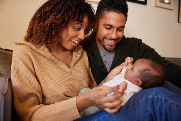 istock Laughing young parents playing with baby boy at home 1368400782