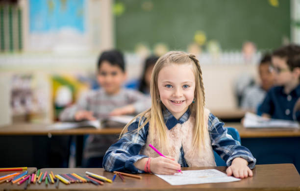 istock Little Girl Coloring at her Desk 1368401264
