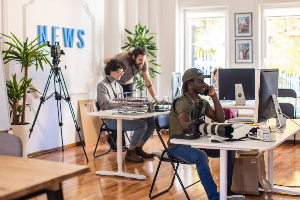 istock Multiracial photographers editing the photos on computer, at the office 1368402396