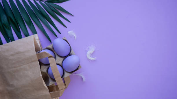 istock Easter eggs on a lilac background. Easter. Reusable paper eco bag. Holiday postcard. 1368403088