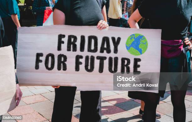 The Phrase Friday For Future Drawn On A Carton Banner In Womans Hand Movement Against Climate Change A Girl Holds A Cardboard With An Inscription Friday For Future Stock Photo - Download Image Now