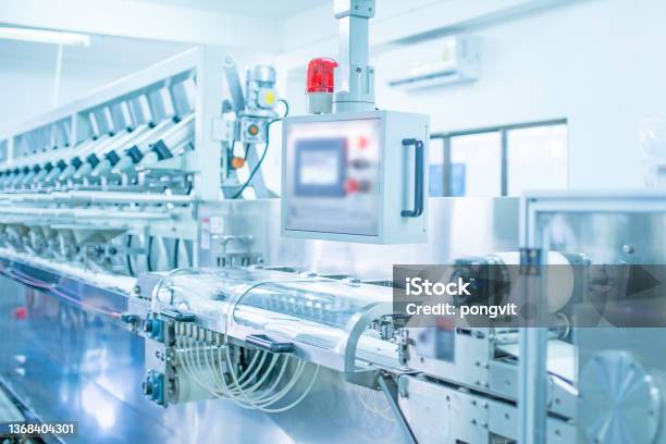 Factory Industrial Area Automation Technology Machines For Packing Products Within The Factory Sterile Beauty Industry In Order To Maintain Maximum Cleanlinessshallow Focus Effectn Stock Photo - Download Image Now