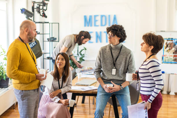 istock Multiracial journalists and editors talking at the office 1368404588