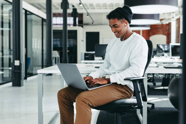 istock Happy young businessman working on a new project in the office 1368406163