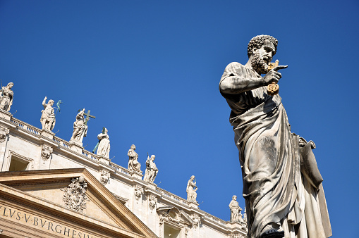 Vatican City - March 13, 2016: The statue of Saint Peter in Piazza San Pietro in Vatican is worshipped and visited every year by crowd of pilgrims and tourists