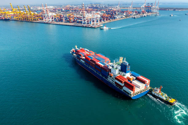 istock Aerial view of cargo ship and cargo container in harbor. 1368406321