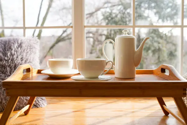 Fresh morning tea.Mug on window sill at home. Good mood concept.Indoors
