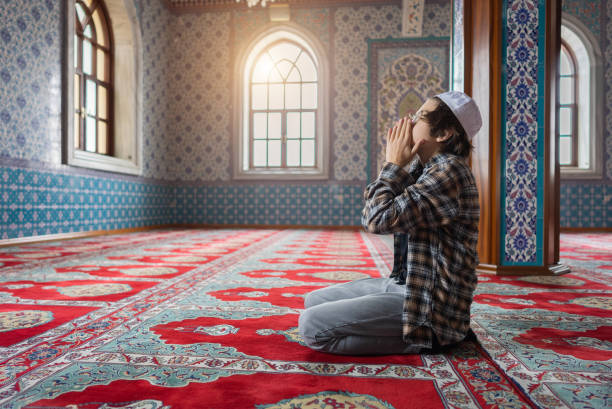 istock The Muslim young boy prays in the mosque. 1368407952