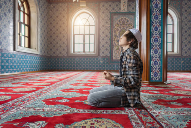 istock The Muslim young boy prays in the mosque. 1368407997