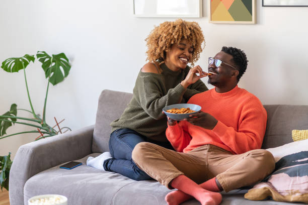 istock The couple is relaxing on the sofa and watching tv 1368408148