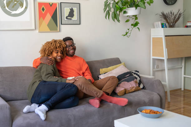 istock The couple is relaxing on the sofa and watching tv 1368408155