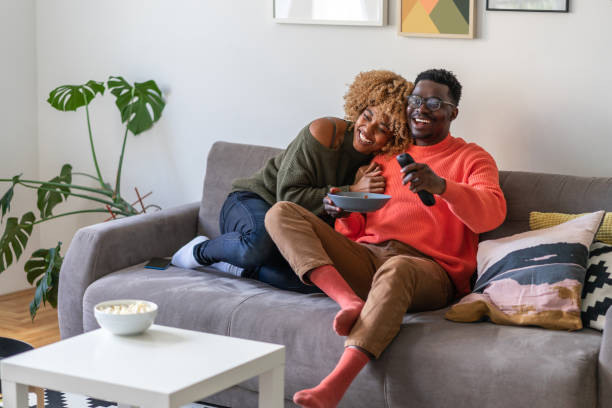 istock The couple is relaxing on the sofa and watching tv 1368408164
