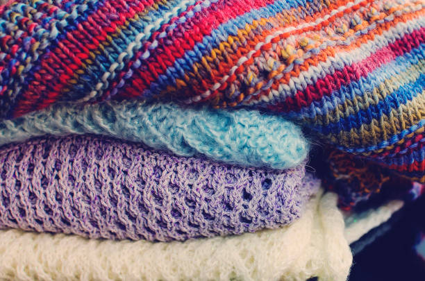 istock Stack of women's knit cardigans and sweaters. Close-up, selective focus. 1368411888