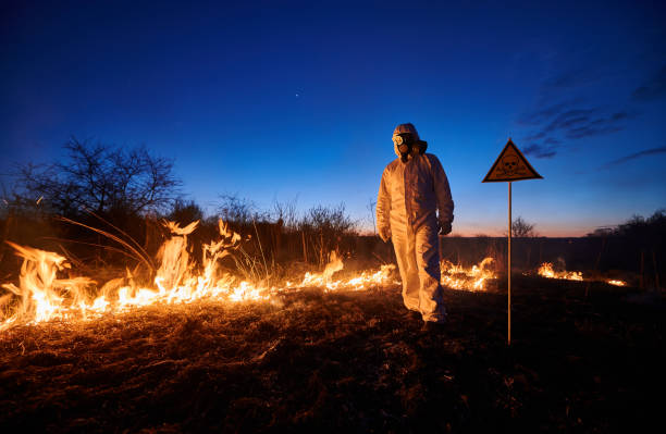 istock Firefighter ecologist working in field with wildfire. 1368412195