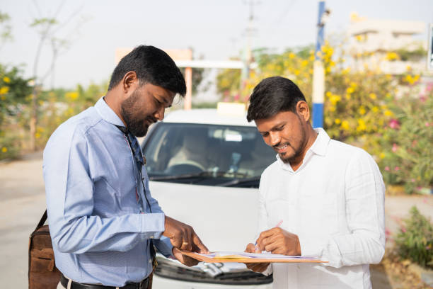 istock cab driver signing on insurance or loan agreement documents in front of car - concept approval of vehical or personal loan, self employment and financial support. 1368412458