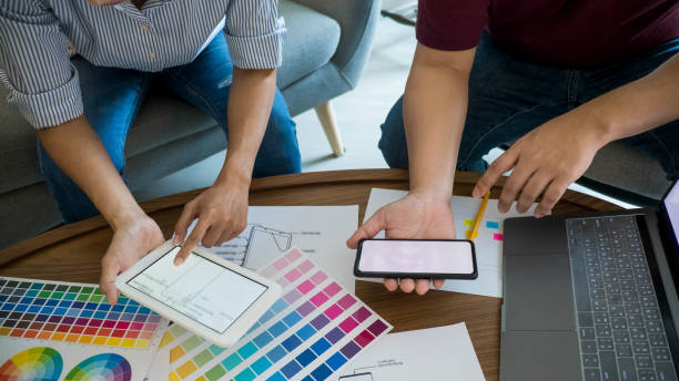istock Graphic design and color swatches and pens on a desk. Architectural drawing with work tools and accessories. 1368412662