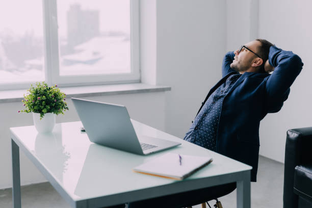 istock A time for relax. Young businessman is relaxing in his office. 1368413556