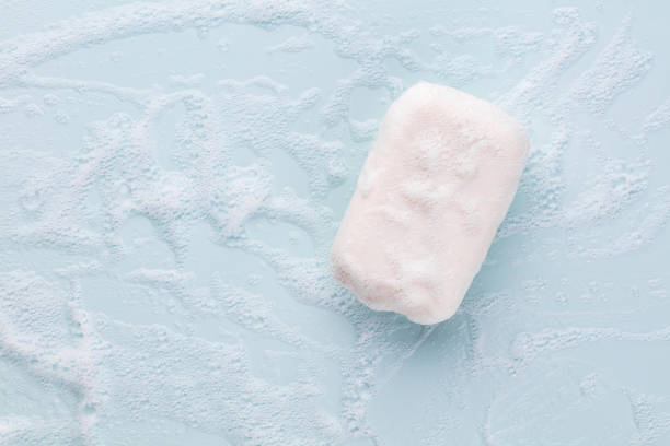istock Soap bar and foam on white background, top view. Mockup for design 1368413951
