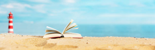 istock Book on the beach with sea in the background 1368413981