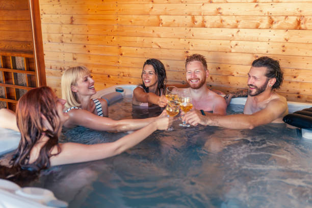 istock Friends making a toast in hot tub while on vacation 1368415410