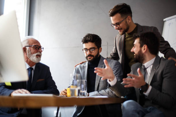 istock Three younger colleagues are talking with senior management. 1368415654