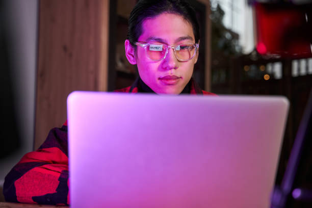 istock Asian man browsing inappropriate sites at the laptop while sitting at the room 1368415938