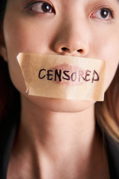 Asian woman with taped mouth with the word censored in China stock photo