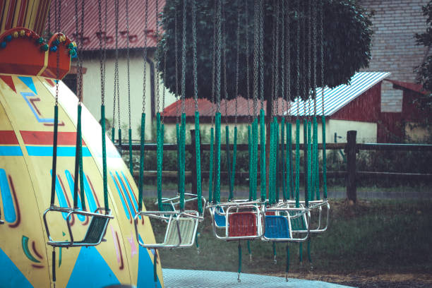 empty chain carousel - swing playground empty abandoned imagens e fotografias de stock