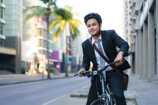 Businessman traveling through the city with his bicycle