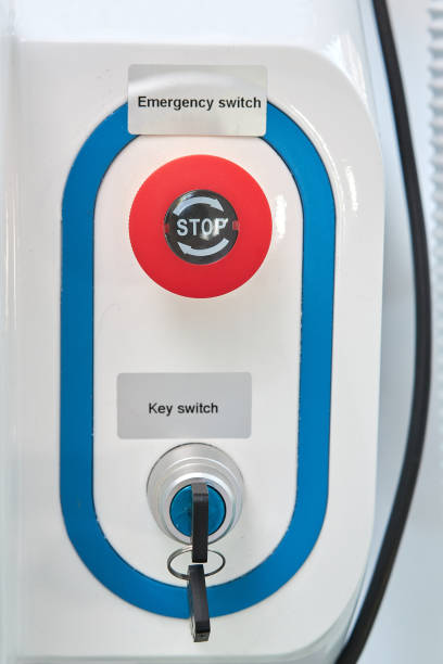 istock Equipment switch-on lock with two keys and a red emergency shutdown button with the inscription STOP on a white background 1368418767