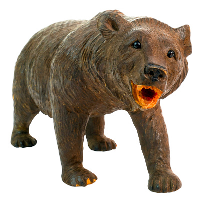 Vintage carved bear isolated on white. Angry wild expression.