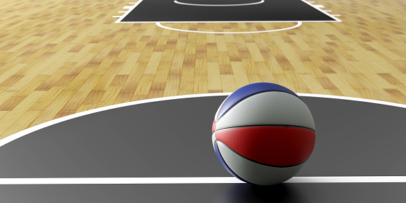 3d rendering of basketball ball Laying On The Floor in a sports court