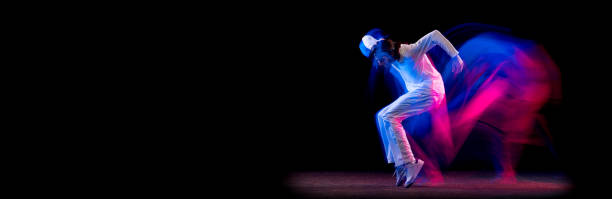 istock Flyer with stylish man, hip-hop dancer dancing isolated on dark background in mixed neon light. Youth culture, hip-hop, movement, style and fashion, action. 1368421454