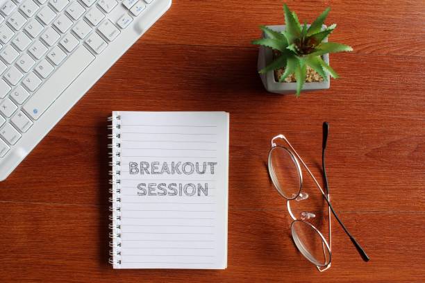 Keyboard, glasses and notebook with text BREAKOUT SESSION. Top view image of keyboard, glasses and notebook with text BREAKOUT SESSION. escaping stock pictures, royalty-free photos & images