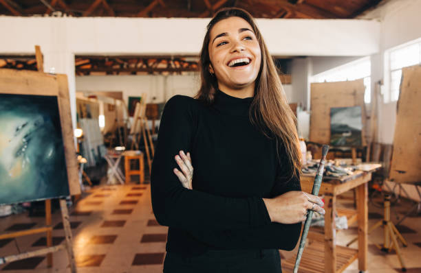 istock Artistic entrepreneur laughing cheerfully in her workshop 1368423332