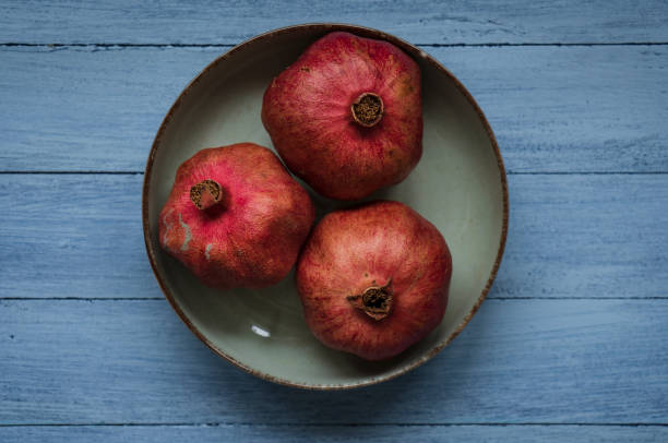 istock Pomegranate fruit on wooden background 1368424691