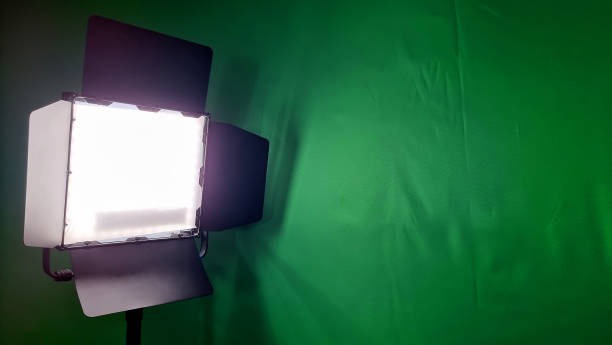 istock close up view of a video light in front of a green screen with blank space for design. led studio light for photographic, live, social media works. 1368427607