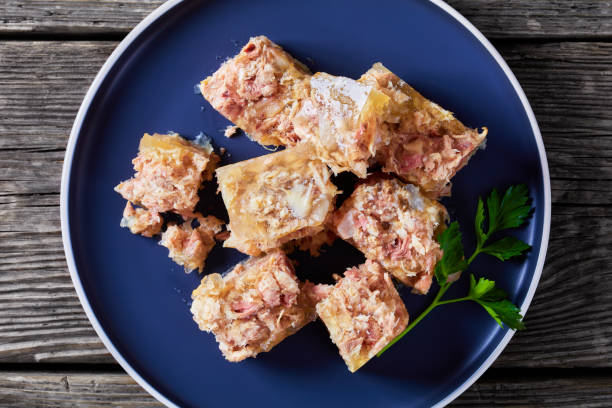 meat aspic, jellied slow cooked meat on a plate meat aspic, jellied slow cooked meat on a plate on a rustic wooden table, close-up, flat lay, aspic stock pictures, royalty-free photos & images