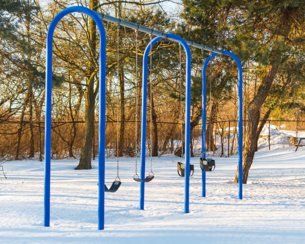 istock Children's swings with park with snow 1368429825